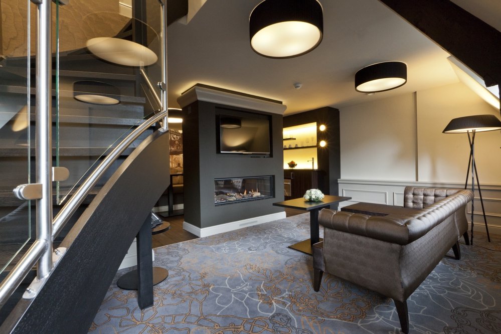 Spacious lounge area with flatscreen TV and fireplace